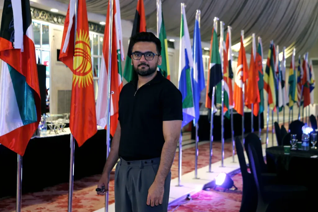 Ali at the Sustainable Tourism Forum 2026 roundtable session inside PC Hotel Karachi with OIC country flags in the background