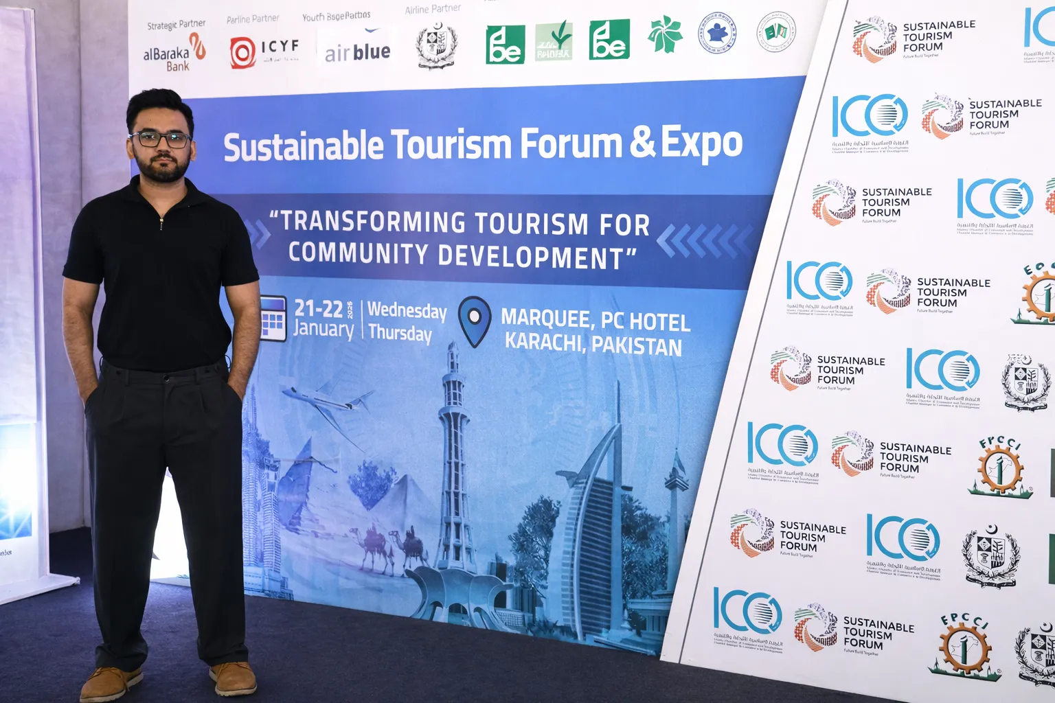 Ali, founder of Zaviamo, standing at the Sustainable Tourism Forum & Expo 2026 banner at PC Hotel Karachi