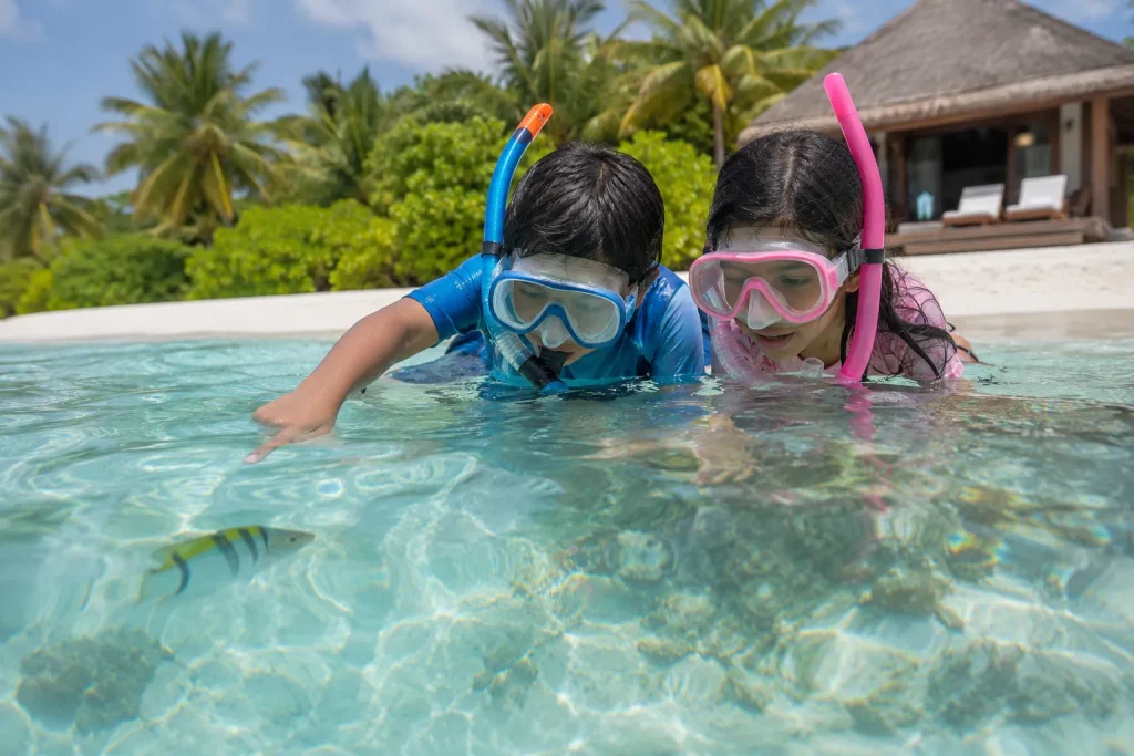 Children snorkelling at a halal-friendly family resort in Maldives for Eid holidays