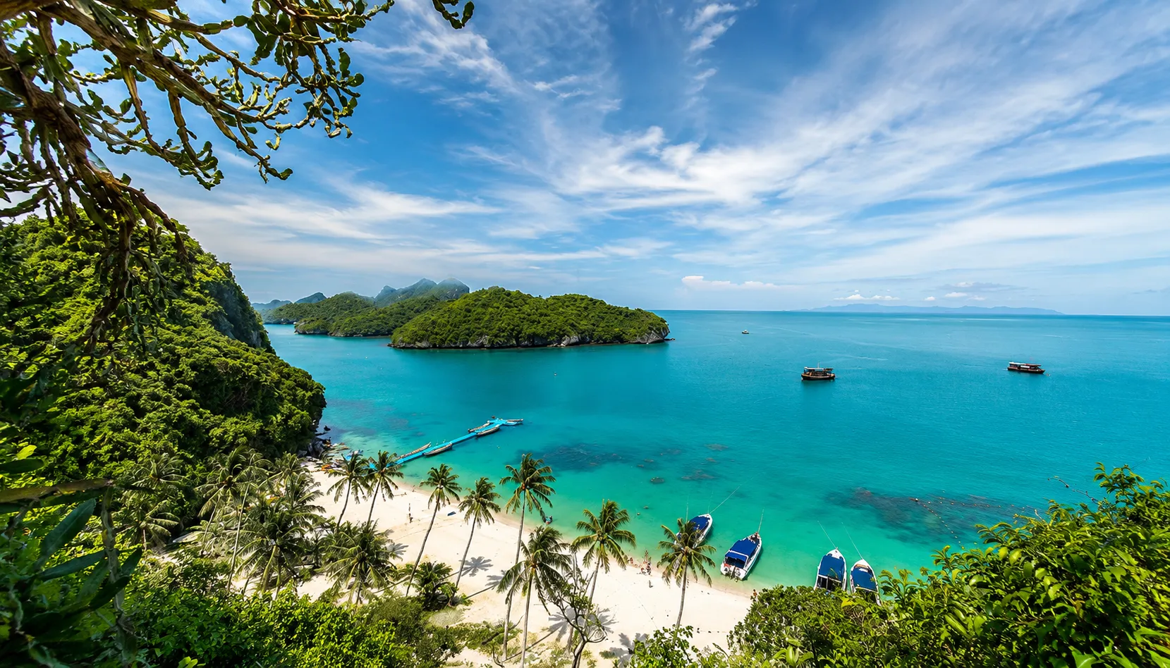 Aerial view of turquoise bay and longtail boats, Koh Samui wellness retreat island scenery
