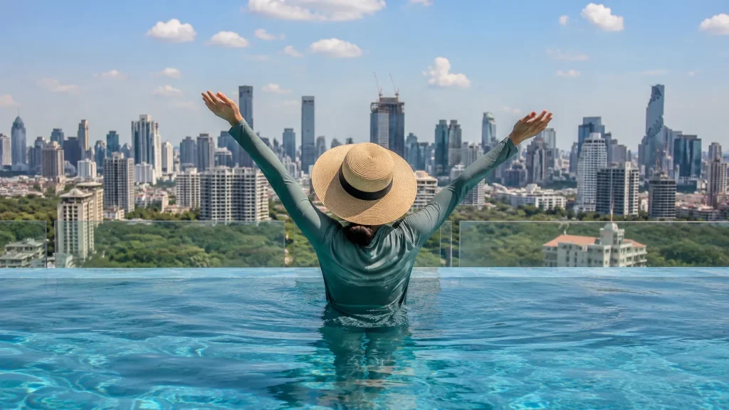 Woman in a pool captured behind her to cover the Bangkok