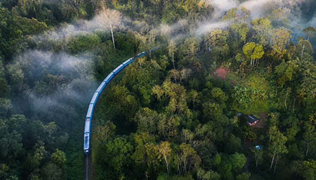 Blue train winding through Sri Lanka hill country rainforest mist aerial, sri lanka eta free for pakistanis