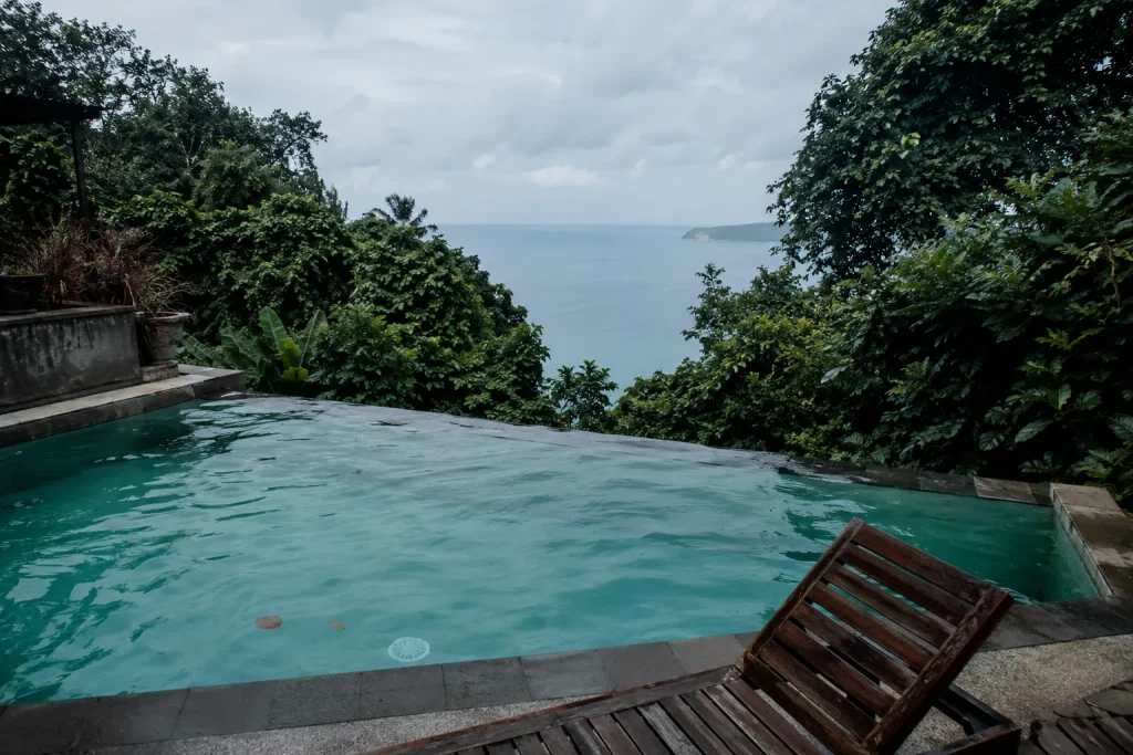 Hillside infinity pool at a mid-range Thailand wellness retreat overlooking the Gulf