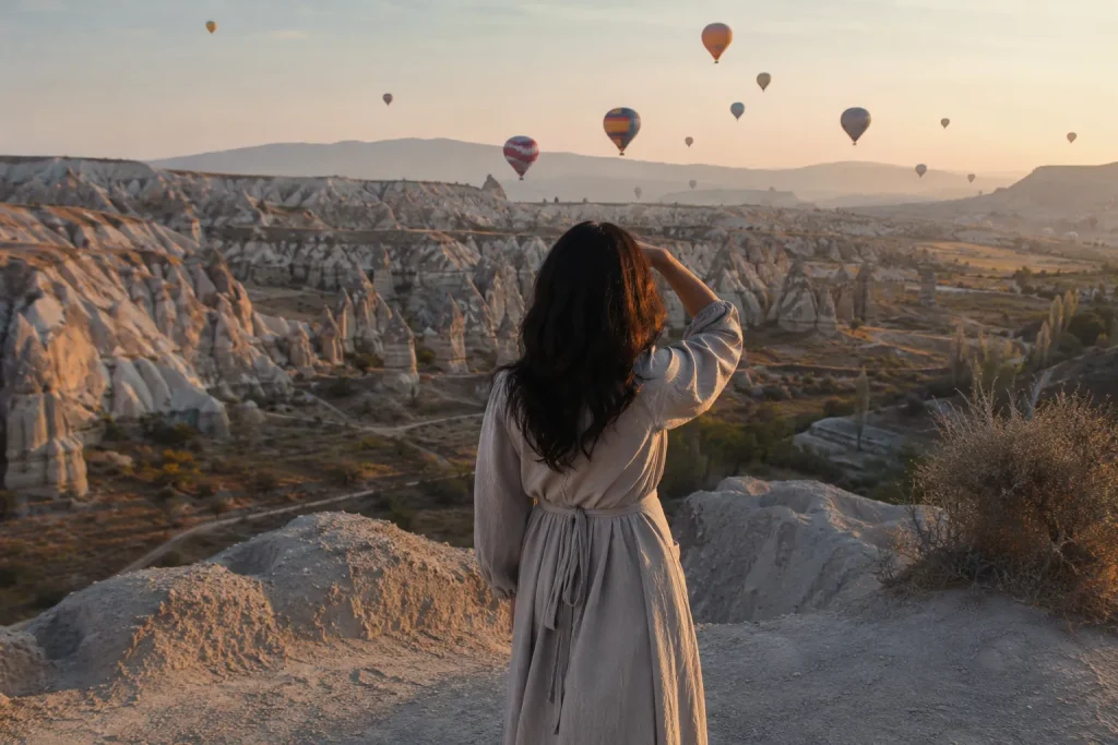 Solo woman traveler overlooking Cappadocia's valley, reflecting the rise of solo travel Turkey