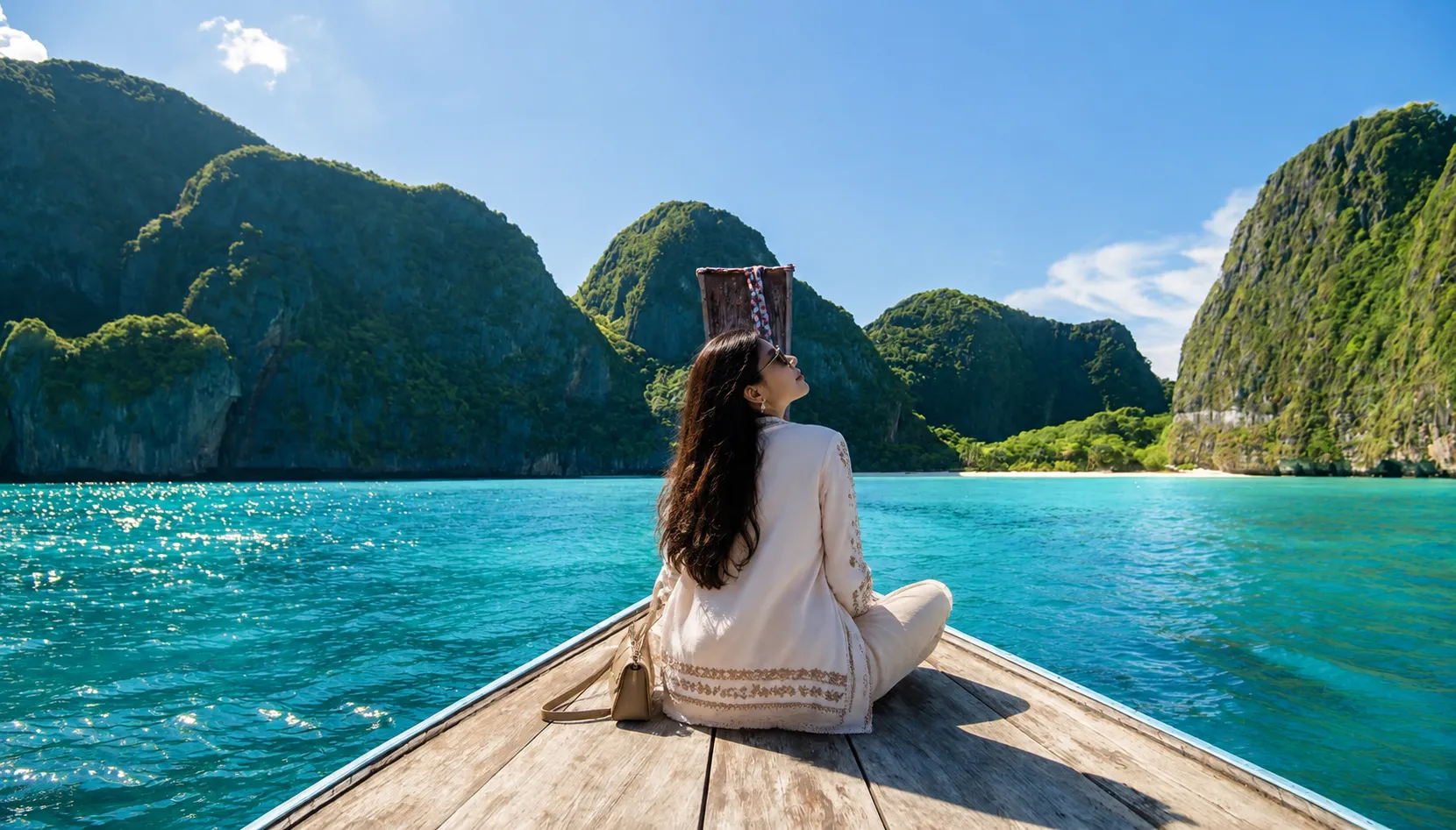Longtail boat trip through Andaman coast limestone cliffs, best after October for a Thailand family holiday