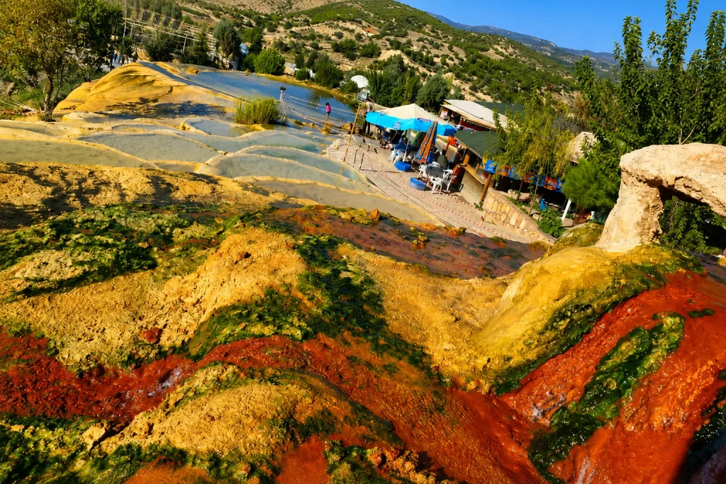 Iron-red travertine pools at Karahayıt near Pamukkale, a rare stop for Turkey thermal springs travel