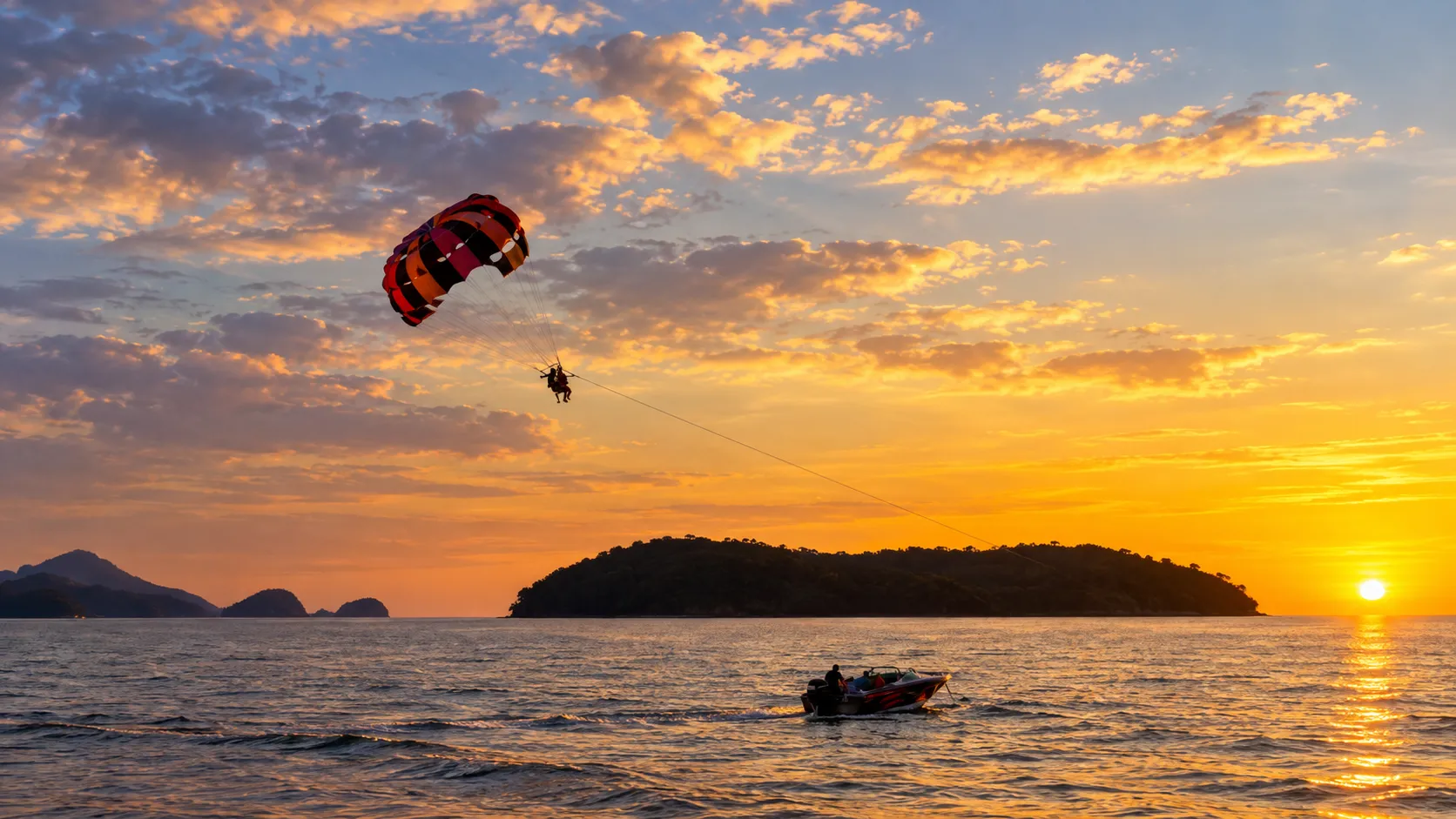 Parasailing at sunset off the Langkawi coast, Malaysia, after a Malaysia eVisa from Pakistan