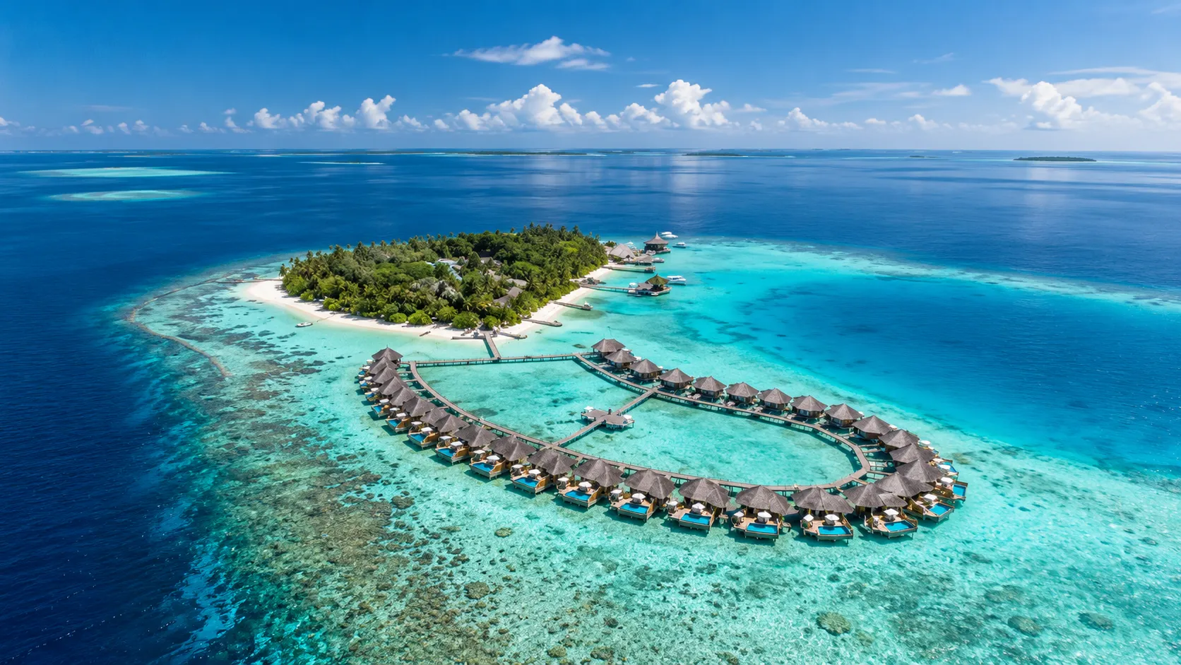 Aerial view of an overwater villa ring on a Maldives atoll, a top layout among Maldives family resorts