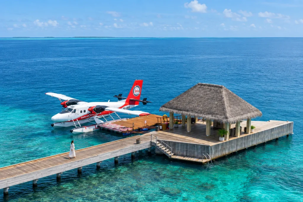 Seaplane docked at a resort jetty, illustrating the daylight transfer window for Maldives family resorts