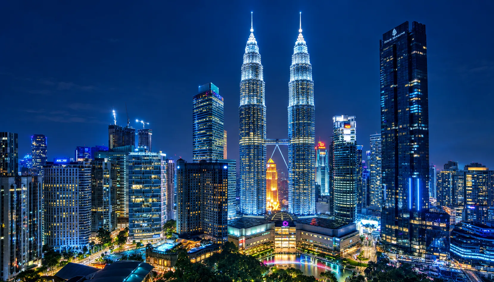 Kuala Lumpur's skyline lit up at night, with the Petronas Twin Towers anchoring a solo Kuala Lumpur trip.