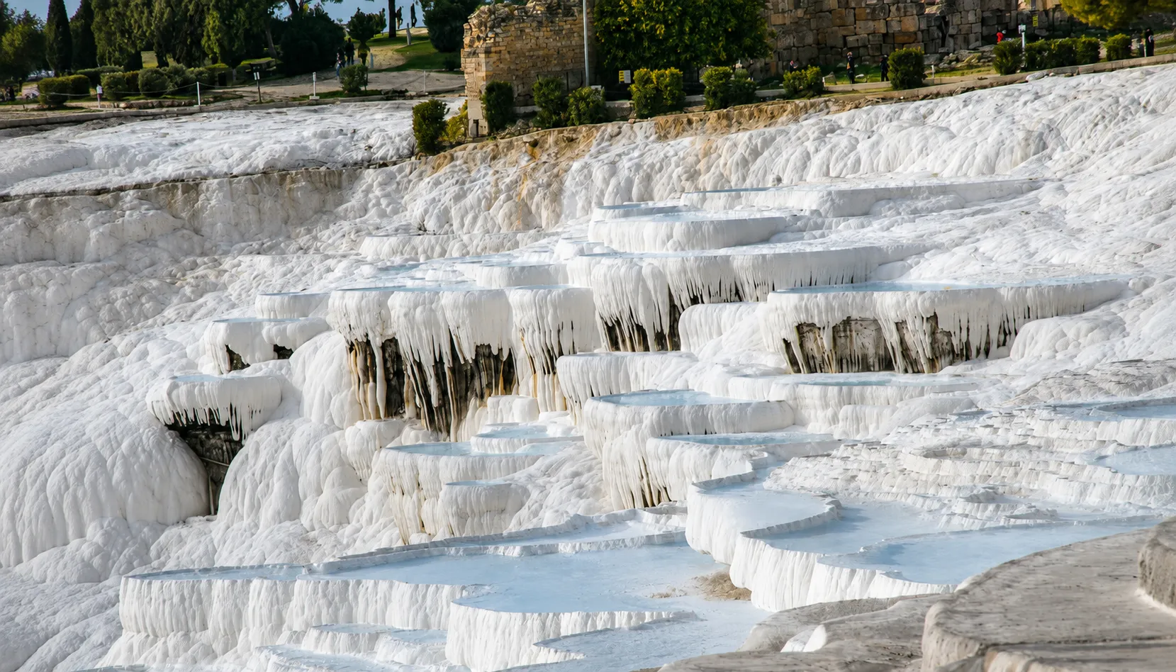 Pamukkale's white travertine terraces, the calcium formations behind Turkey's best-known thermal springs