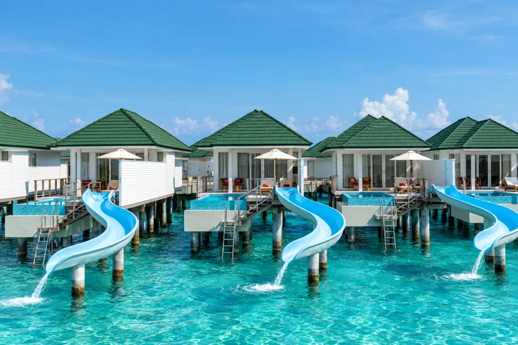 Overwater villas with private slides into the lagoon, the family setup worth booking ahead of December
