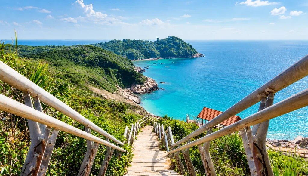 Rocky headland steps above a bay on Malaysia’s east coast, rough in December monsoon season