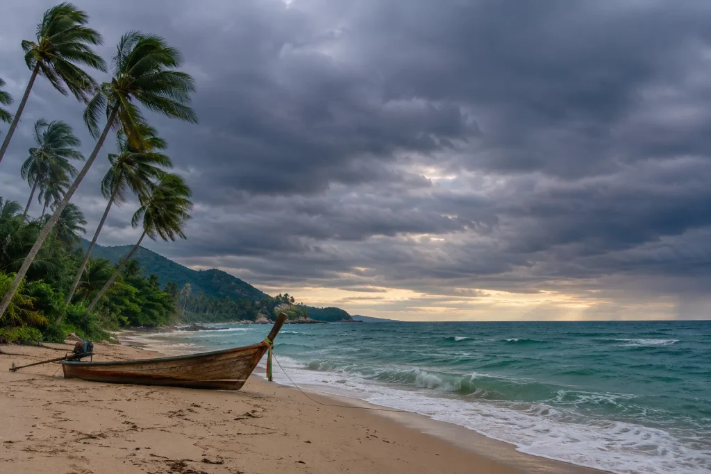 Longtail boat on a stormy southern Thailand beach, a weather check for a Thailand DTV visa trip from Pakistan