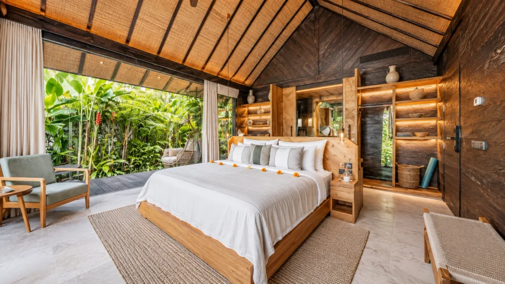 Eco bungalow bedroom with teak bed and open garden view, a north Bali coast stay near Pemuteran dive sites