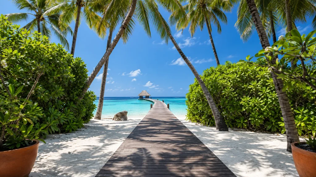 Palm-lined boardwalk leading to a lagoon pavilion, a Maldives escape for solo travel on a Pakistani passport