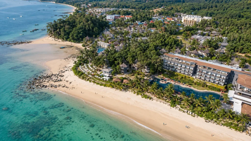 Aerial view of a Thailand beach resort with a sandy shoreline and turquoise water, December flights from Karachi